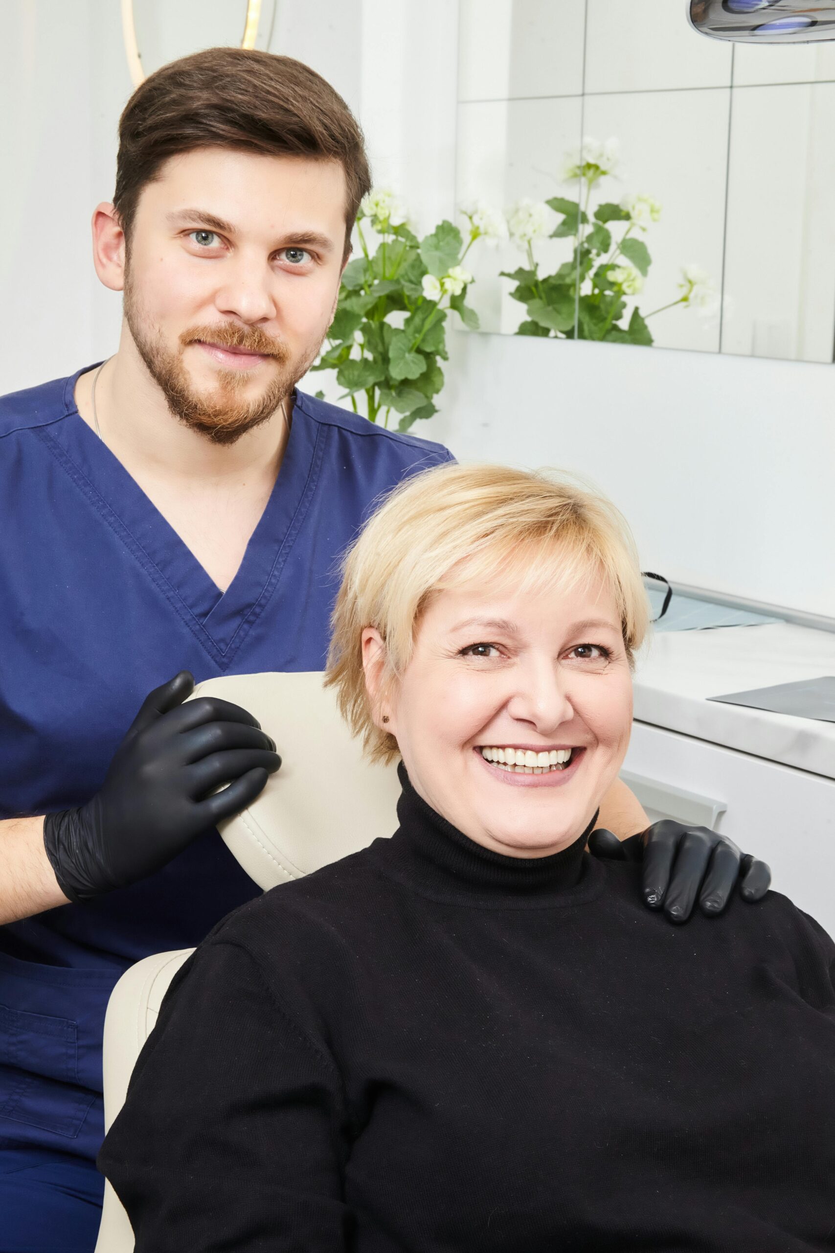 Smiling dentist with a patient in a modern Belgrade clinic.